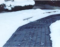 Asphalt driveway retrofitted with radiant snow melting cable.