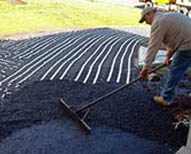 Asphalt driveway being retroffited with electric snow melting system.