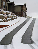 Steep driveway with electric radiant snow melting system installed.